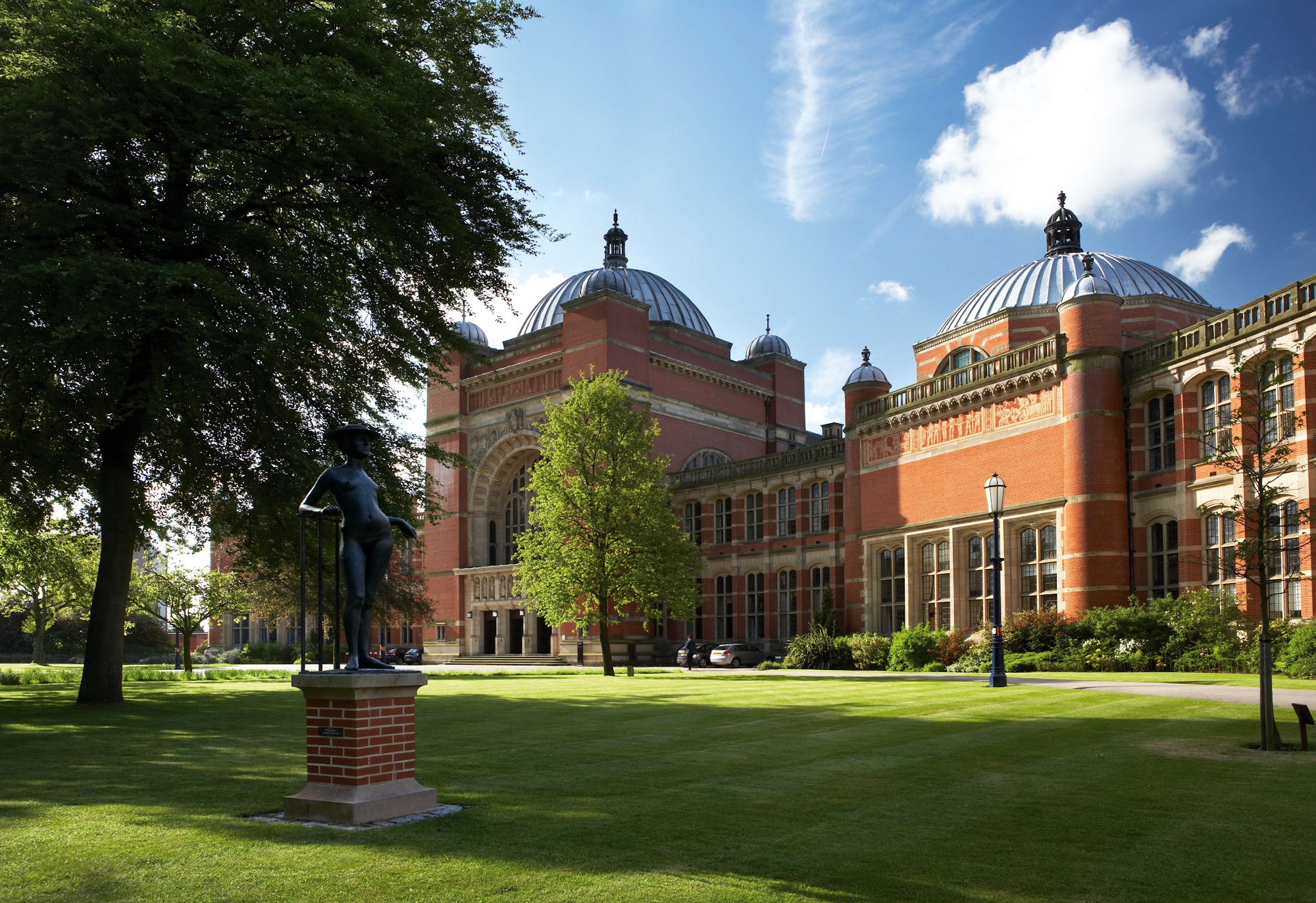 Picture of red-brick buildings and grass on The University of Birmingham campus