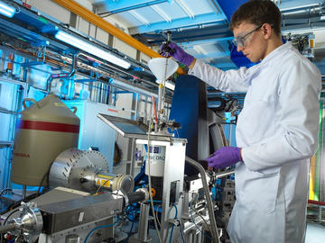 Researcher loading sample onto beamline Researcher loading sample onto beamline